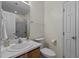 Well-lit bathroom featuring a vanity with a sink, toilet, and a shower with glass doors at 613 Flaherty Ave, Wake Forest, NC 27587