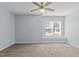 Light-filled bedroom featuring carpet, a ceiling fan, and large window at 613 Flaherty Ave, Wake Forest, NC 27587