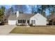 Charming single-story home with white siding, well-maintained lawn, and attached garage at 613 Flaherty Ave, Wake Forest, NC 27587