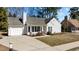 Charming single-story house with white siding, attached garage, and well-manicured front yard at 613 Flaherty Ave, Wake Forest, NC 27587