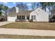 Inviting single-Gathering home featuring a well-kept lawn, brick accents, and a charming front entrance at 613 Flaherty Ave, Wake Forest, NC 27587