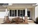 Up close view of the front porch featuring brick column bases and house number at 613 Flaherty Ave, Wake Forest, NC 27587
