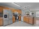 Contemporary kitchen featuring stainless steel appliances, white backsplash, and ample cabinet space at 613 Flaherty Ave, Wake Forest, NC 27587