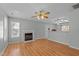 Bright living room featuring hardwood floors, fireplace, and ample natural light at 613 Flaherty Ave, Wake Forest, NC 27587