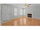 Cozy living room with fireplace, two windows, and a view of the front door at 613 Flaherty Ave, Wake Forest, NC 27587