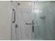 Modern shower with sleek glass door, marbled walls and updated fixtures at 613 Flaherty Ave, Wake Forest, NC 27587