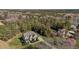 Aerial view of a home in a wooded community with a large, green lawn and long driveway at 690 Hawthorne Pl, Creedmoor, NC 27522