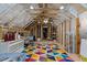 Spacious attic with exposed rafters, colorful rug, and ample storage space at 690 Hawthorne Pl, Creedmoor, NC 27522