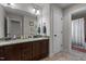 Bathroom featuring vanity with granite countertop, double sinks, and dark wood cabinetry at 690 Hawthorne Pl, Creedmoor, NC 27522