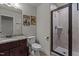 Nicely finished bathroom with glass shower, granite counters and comic wall art at 690 Hawthorne Pl, Creedmoor, NC 27522