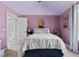Cozy bedroom with purple walls, white trim, double bed and ample natural light at 690 Hawthorne Pl, Creedmoor, NC 27522