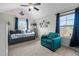 Inviting bedroom boasts lots of light, a charming daybed and a comfy turquoise chair at 690 Hawthorne Pl, Creedmoor, NC 27522