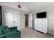 Bright bedroom featuring a chandelier, television, and green armchair at 690 Hawthorne Pl, Creedmoor, NC 27522