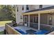 View of the outdoor deck with seating, BBQ grill and screened in porch at 690 Hawthorne Pl, Creedmoor, NC 27522