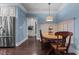 Charming dining area features a built-in bench, hardwood floors, and a stylish light fixture at 690 Hawthorne Pl, Creedmoor, NC 27522