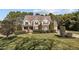 Traditional home with mature landscaping, a well-manicured lawn, and a welcoming front porch at 690 Hawthorne Pl, Creedmoor, NC 27522