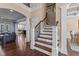 Two-story foyer with hardwood flooring and elegant staircase, with living spaces in the background at 690 Hawthorne Pl, Creedmoor, NC 27522
