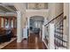 Two-story foyer with hardwood flooring and elegant staircase with wooden handrail and iron spindles at 690 Hawthorne Pl, Creedmoor, NC 27522