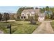 Beautiful two-story home with a well-manicured lawn, mature landscaping, and an attached two-car garage at 690 Hawthorne Pl, Creedmoor, NC 27522