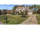 Beautiful two-story home with a well-manicured lawn, mature landscaping, and an attached two-car garage at 690 Hawthorne Pl, Creedmoor, NC 27522