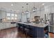 Beautiful kitchen with island bar, stainless appliances, tile backsplash, and hardwood floors at 690 Hawthorne Pl, Creedmoor, NC 27522
