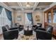 Inviting living room with coffered ceilings, leather chairs, and elegant decor at 690 Hawthorne Pl, Creedmoor, NC 27522