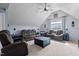 Spacious living room featuring comfortable seating, a ceiling fan, and natural light from the windows at 690 Hawthorne Pl, Creedmoor, NC 27522