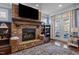 Cozy living room with stone fireplace and french doors that lead to a patio at 690 Hawthorne Pl, Creedmoor, NC 27522