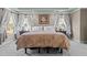 Large main bedroom featuring a king-size bed, ceiling fan, and windows providing ample natural light at 690 Hawthorne Pl, Creedmoor, NC 27522