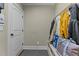 Well-organized mudroom with coat rack, storage bench, and convenient access to the home at 690 Hawthorne Pl, Creedmoor, NC 27522