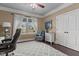 Comfortable home office featuring a cozy gray chair and a large window, perfect for a productive workspace at 690 Hawthorne Pl, Creedmoor, NC 27522