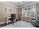 Well-lit home office with a large window, desk, and a comfortable chair provides an ideal workspace at 690 Hawthorne Pl, Creedmoor, NC 27522