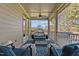 Inviting covered porch with comfortable seating, decorative rug, and a view of the outdoors at 690 Hawthorne Pl, Creedmoor, NC 27522
