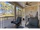 Relaxing screened-in porch with comfortable chairs and a view of the peaceful surroundings at 690 Hawthorne Pl, Creedmoor, NC 27522