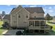 Two-story traditional home featuring a rear screened porch and patio area at 690 Hawthorne Pl, Creedmoor, NC 27522
