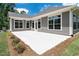 Backyard with concrete patio, landscaping, and mature lawn at 720 Shell Bank Ct, Cary, NC 27519