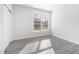 Bright bedroom with wood-look flooring and modern window at 720 Shell Bank Ct, Cary, NC 27519