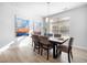 Bright dining room features modern light fixture and large window for abundant natural light at 720 Shell Bank Ct, Cary, NC 27519