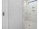 Modern shower featuring white marble-look tile and recessed shelving at 720 Shell Bank Ct, Cary, NC 27519