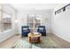 Cozy sitting room featuring two comfortable chairs, a round coffee table, and lots of natural light at 720 Shell Bank Ct, Cary, NC 27519