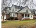 Charming brick and siding home featuring a covered porch and well-maintained landscaping at 7710 Astoria Pl, Raleigh, NC 27612