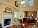 Elegant living room showcasing a fireplace, hardwood floors, and a dining area at 7710 Astoria Pl, Raleigh, NC 27612