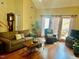 Comfortable living room features hardwood floors, a ceiling fan and natural light from the balcony at 7710 Astoria Pl, Raleigh, NC 27612