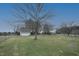 A fenced in backyard with two small sheds and a garage at 8510 Polaris Dr, Bahama, NC 27503