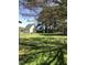 Spacious backyard showcases a detached garage with mature trees and a lush green lawn at 8510 Polaris Dr, Bahama, NC 27503