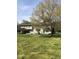 Expansive backyard featuring a covered patio area and large, well-maintained lawn at 8510 Polaris Dr, Bahama, NC 27503