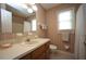 Traditional bathroom with a white sink, patterned wallpaper, and window at 8510 Polaris Dr, Bahama, NC 27503