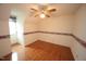 Hardwood floors and a ceiling fan make this bedroom an inviting space at 8510 Polaris Dr, Bahama, NC 27503