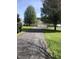 Long driveway leads to a home with an attached three-car garage, providing ample parking space and curb appeal at 8510 Polaris Dr, Bahama, NC 27503
