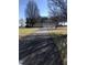 Long driveway leading up to a two-story home with a three-car garage and spacious yard at 8510 Polaris Dr, Bahama, NC 27503